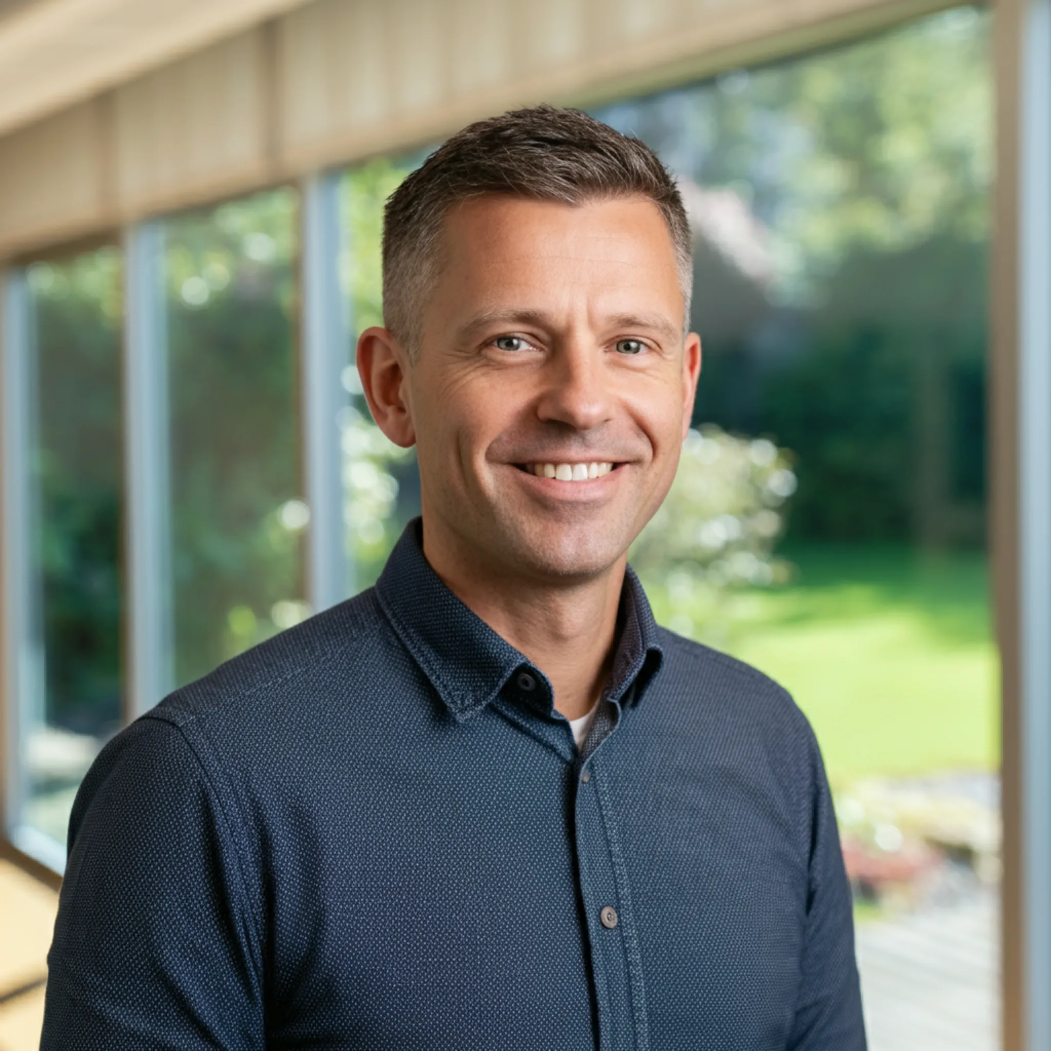 Professional man in a blue polo shirt, outdoor setting